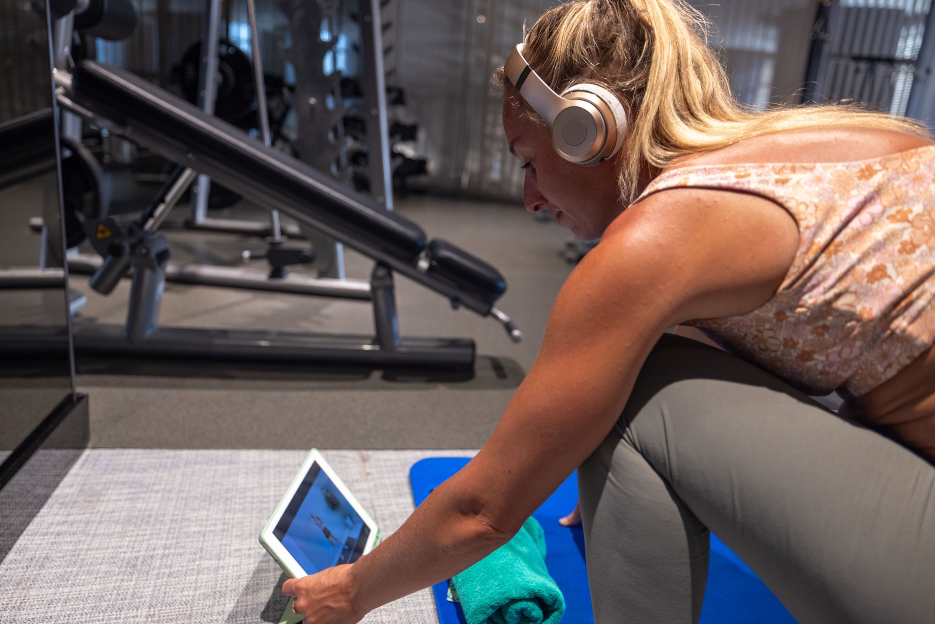 Woman Using A Tablet for Workout Guidance in Gym